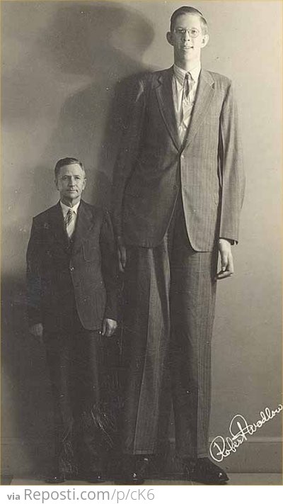 The tallest man to have ever lived, standing next to his father