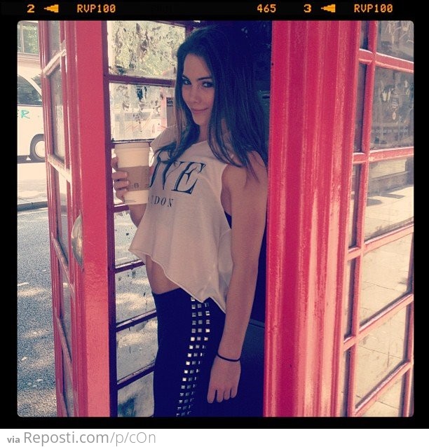 Casually dressed McKayla Maroney in a phone booth in London