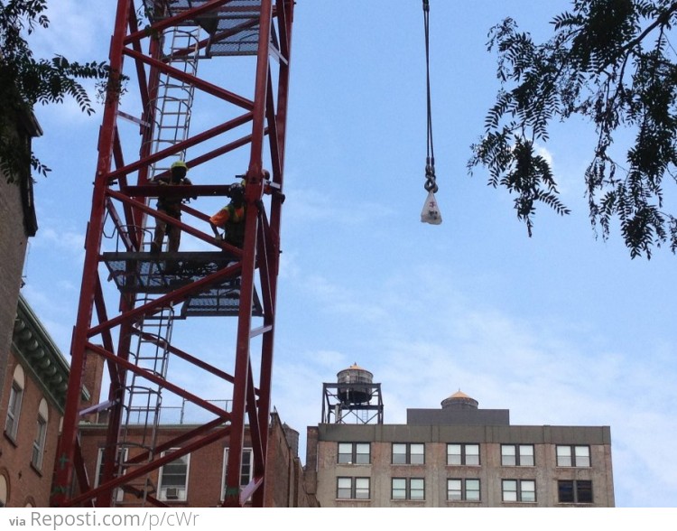 This is 20 story crane. Lifting a guy's lunch.