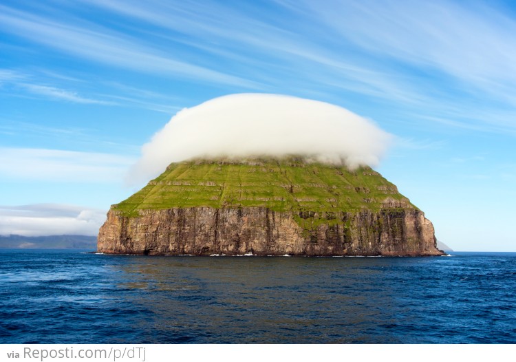 Cloud resting on a mountain