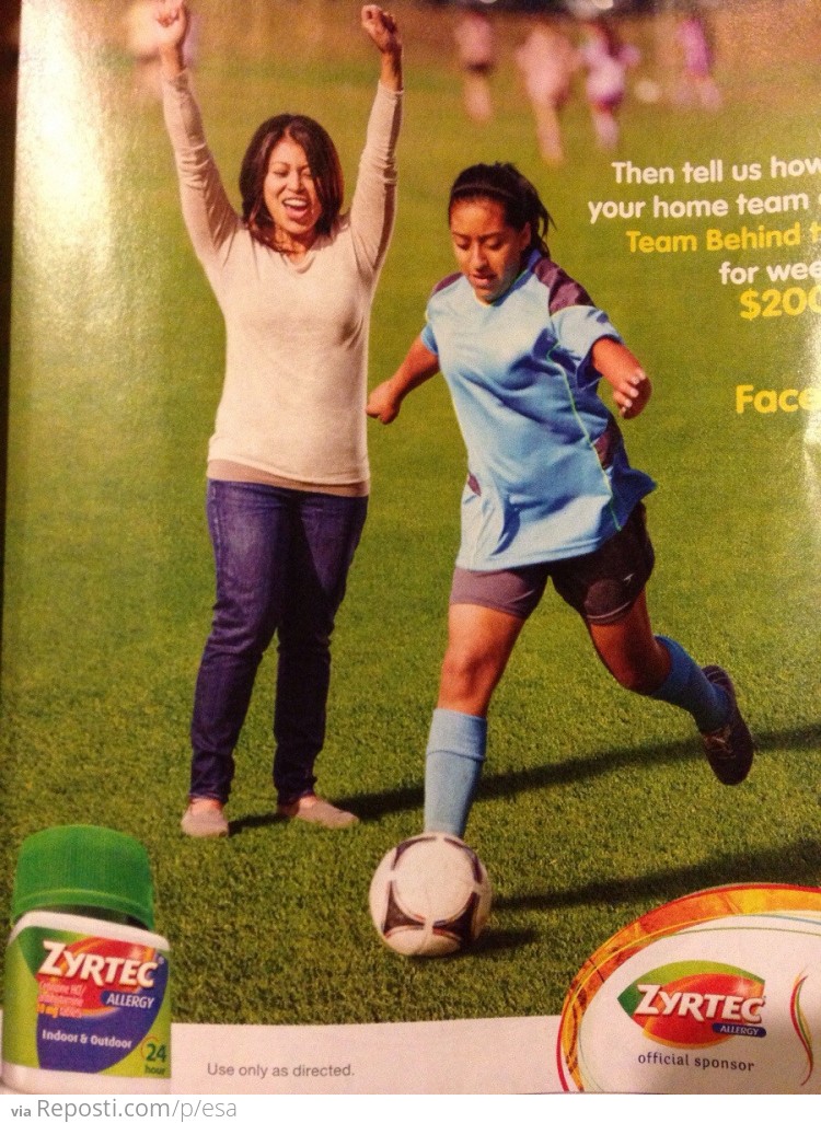 Why is she standing in the middle of the soccer field?