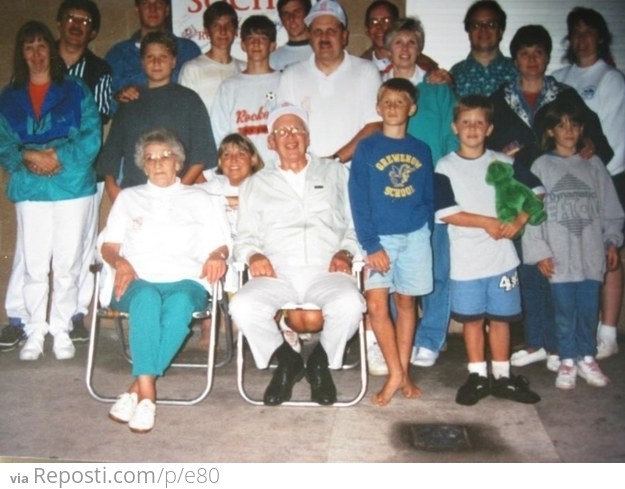 ###gramps has a big family and... that's the woman kneeling down behind him.