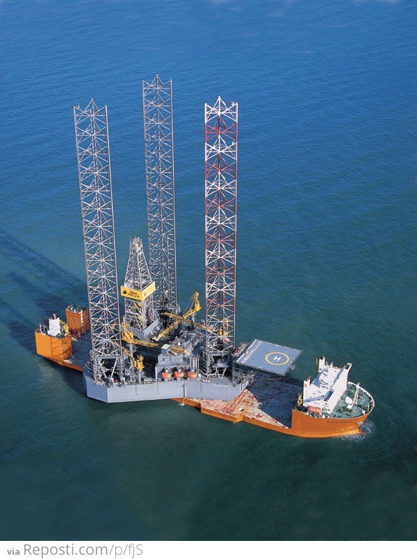 These are drilling rigs with a gridwork of iron below them creating a giant footprint to stabilize the weight. They jack up out of the water with those large legs.