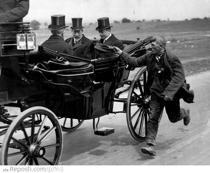 A beggar running alongside King George V’s coach, 1920