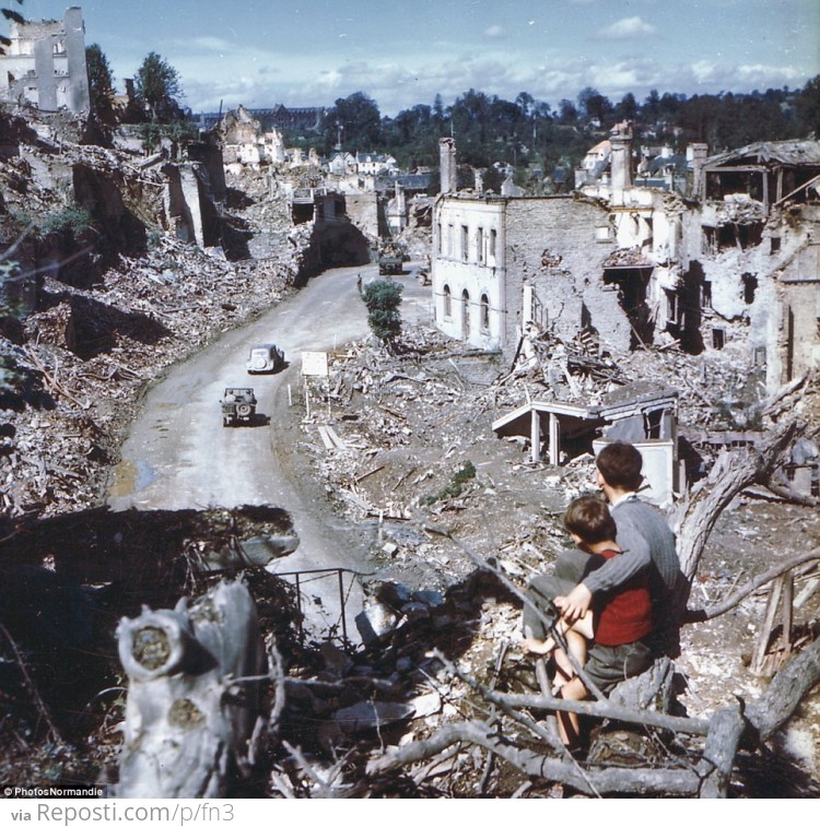 In the aftermath of the D-Day invasion, two boys watch from a tree as American soldiers drive through the town of St. Lo. France