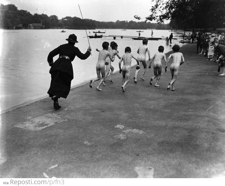 A gang of skinny dippers is chased down the street at Hyde Park by a police woman, 1926