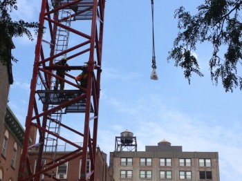 This is 20 story crane. Lifting a guy's lunch.