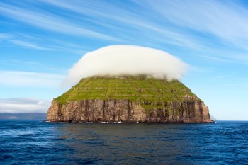 Cloud resting on a mountain