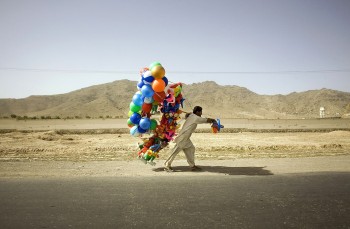 Afghan Man Carries Balloons Alongside A Road Near Kabul
