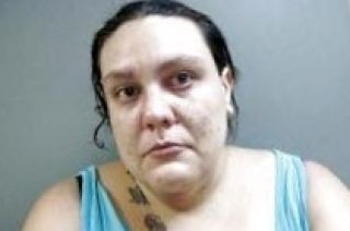 Couple arrested after 2 year old found wandering neighborhood with ax