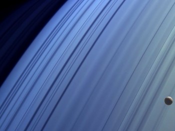 Saturn's moon Mimas drifting in front of its rings